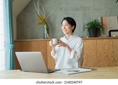 Young Women Who Work Remotely With Coffee