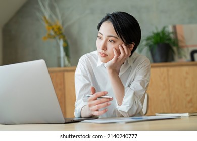 Young women working at home - Shutterstock ID 2140240777