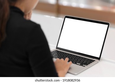Young women working on her laptop with blank copy space screen for your advertising text message in office, Back view of business women hands busy using laptop at office desk.