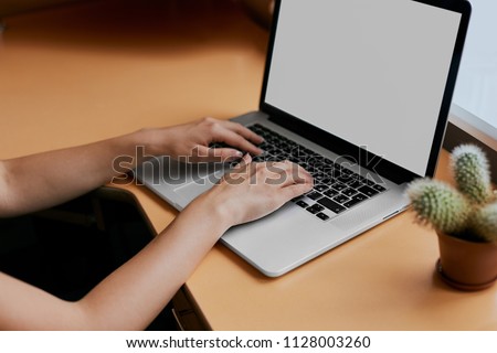 Young women working on her laptop with blank copy space screen for your advertising text message in office, Back view of business woman hands busy using laptop at office desk.