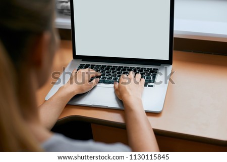 Young women working on her laptop with blank copy space screen for your advertising text message in office, Back view of business woman hands busy using laptop at office desk.