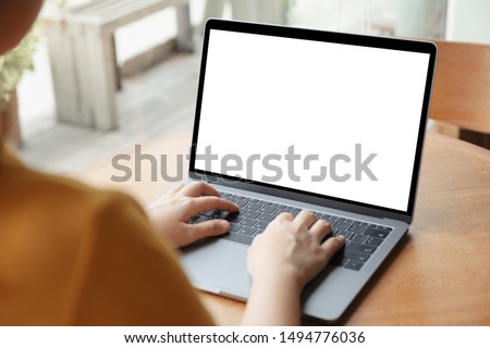 Young women working on her laptop with blank copy space screen for your advertising text message in office, Back view of business women hands busy using laptop at office desk.