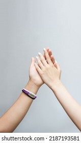 Young Women's Hands Greet Each Other And On One Of Them Is Best Friend Bracelet. Happy Friendship Day. Selective Focus, Copy Space