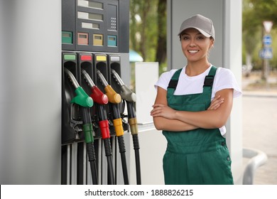 Young Worker With Fuel Pump Nozzle At Modern Gas Station