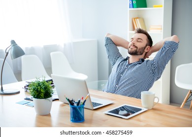 Young worker having break and resting after solving task