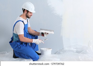 Young worker making repair in room - Powered by Shutterstock