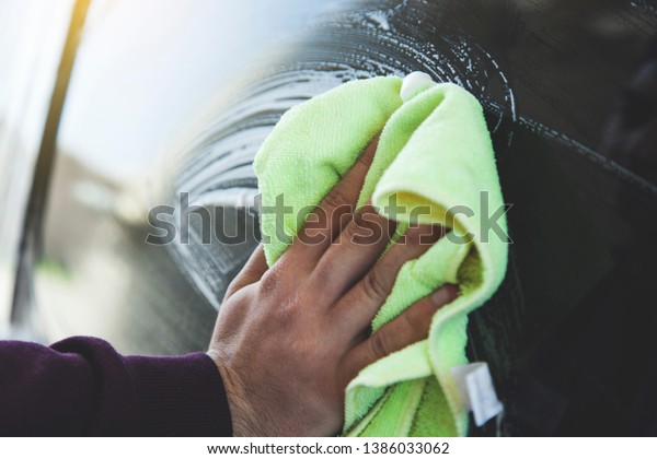 young worker man hand\
cloth washing car