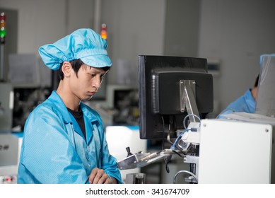 Young Worker On Chinese LED Production Factory In Shenzhen