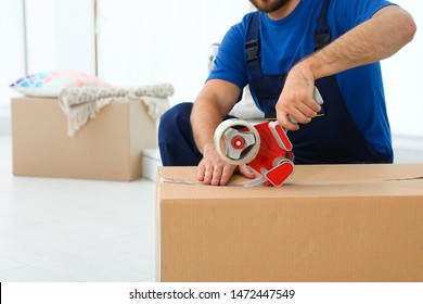 Young Worker Packing Box In Room, Closeup. Moving Service