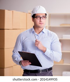 Young Worker In The Postal Office Dealing With Parcels