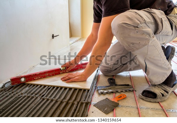 Young Worker Tiler Installing Ceramic Tiles Industrial Stock Image