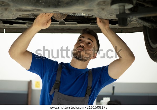 young worker working at\
auto service