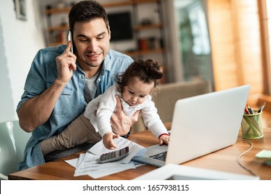 Young working father talking on the phone while babysitting his playful daughter at home.