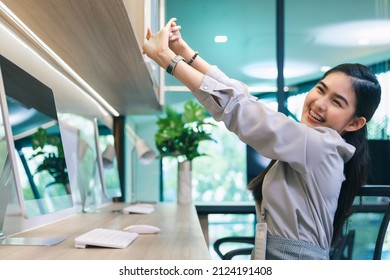 Young Working Female Or Businesswoman Sitting Stretching Arms Relaxing Or Stress Relief At Working Modern Office, Office Syndrome Concept