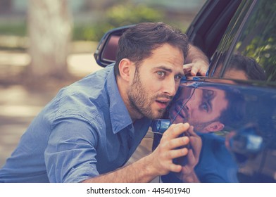 Young Worried Funny Looking Man Obsessing About Cleanliness Of His New Car. Car Care And Protection Concept  