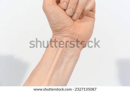 young  wrist with white skin and visible veins