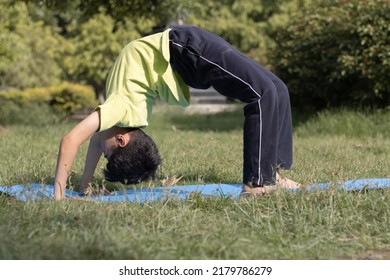 Young Yoga kid boy Practicing Yoga Outdoors in the park in Morning, healthy lifestyle concept - Powered by Shutterstock