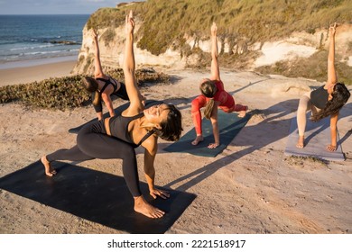 Young yoga practitioners in group doing yoga on nature - Powered by Shutterstock