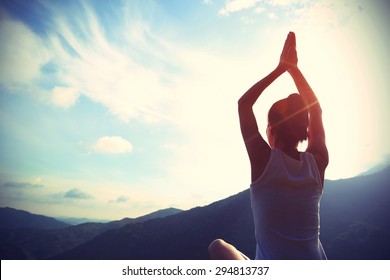young yoga woman sit meditation on sunrise mountain peak  