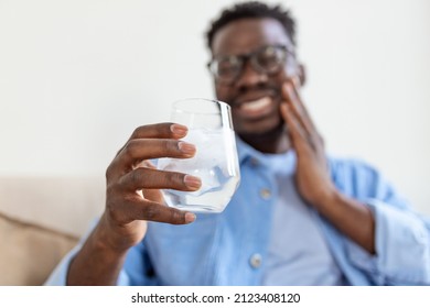 Youngcman With Sensitive Teeth And Hand Holding Glass Of Cold Water With Ice. Healthcare Concept. Man Drinking Cold Drink, Glass Full Of Ice Cubes And Feels Toothache, Pain