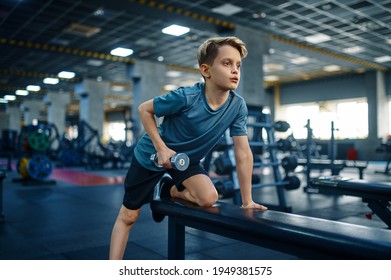 Youngster Doing Exercise With Dumbbell On Bench