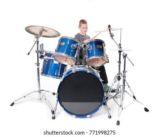 Yount Blond Teen Boy At Drum Kit In Studio Against White Background