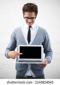 Your Advertisement Goes Here. A Young Nerdy Guy Pointing At Copyspace On His Laptop Screen.