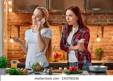 Your Attention, Please Young Female Friends Preparing Together Healthy Meal In Modern Kitchen. Cozy Interior