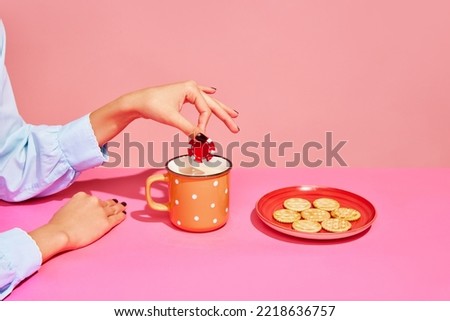Your bets. Food pop art photography. Young girl tasting milk with crackers isolated over pink background. Concept of art, creativity. retro 80s, 70s style. Complementary colors. Copy space for ad
