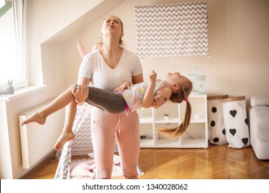 Your Daughter Is Here To Serve You As A Weight For Exercise. Mother And Daughter Working Exercise.