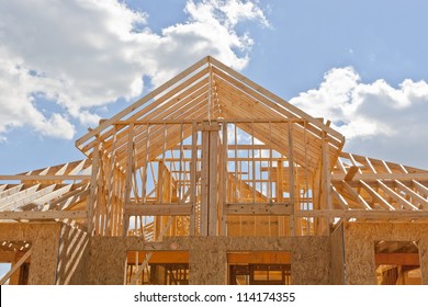 Your Dream Home. New Residential Construction House Framing Against A Blue Sky.