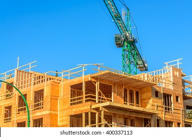 Your Dream Home. New Residential Construction House Framing And Green Crane.