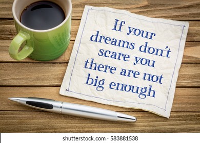 If your dreams don't scare, there are not big enough - handwriting on a napkin with a cup of espresso coffee