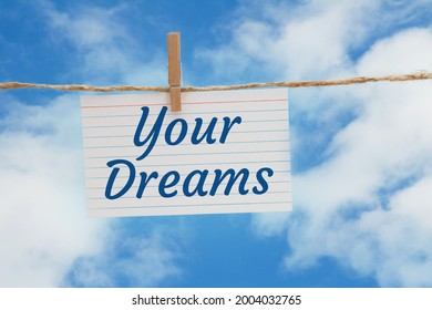 Your Dreams Message On A White Index Card Over Sky