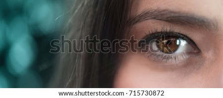 Your eye is the window to your soul - concept human psychology macro photograph. Closeup of an attractive young girls eyelashes and beautiful brown pupil with dreamy look or blurry screen tired vision