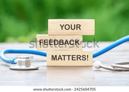 YOUR FEEDBACK MATTERS text on wooden blocks on a green background