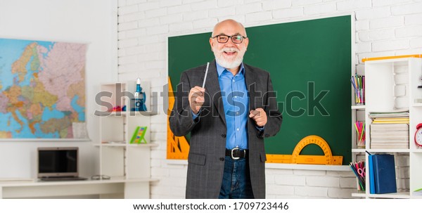 your future in your hands. learn geometry\
easily. become good at geometry. senior man teacher at blackboard.\
bearded tutor in glasses near geography map. back to school. lesson\
in classroom.