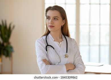 Your health is in professional hands. Thoughtful confident female doctor qualified specialist of modern private clinic stands in office looks aside thinking planning figuring out diagnosis or decision - Shutterstock ID 1845309862