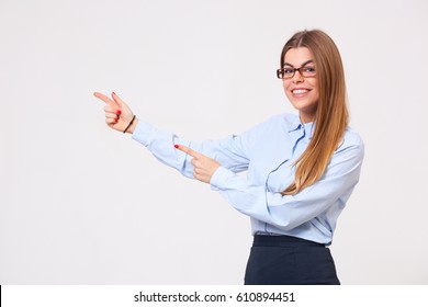 Your Logo Or Product Goes Here! Studio Shot Of Beautiful Young Business Woman Holding Her Arm Up Presenting Copyspace.