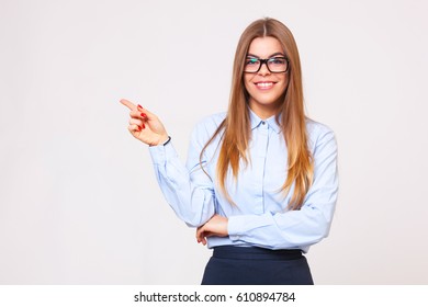 Your Logo Or Product Goes Here! Studio Shot Of Beautiful Young Business Woman Holding Her Arm Up Presenting Copyspace.