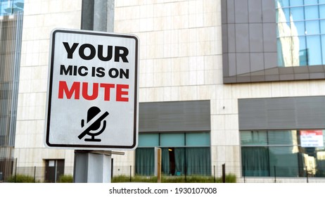 Your Mic Is On Mute Sign In A Downtown City Setting