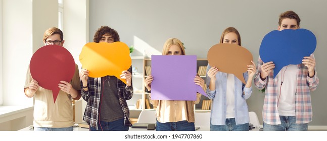 Your opinion matters. Make your voice heard. Group of young people holding multicolored empty cardboard and paper mockup speech bubbles covering their faces trying to get their message across