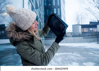 Your pretty woman showing tablet PC outdoors