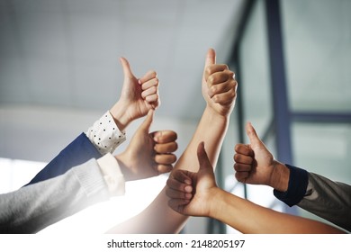 Youre doing a great job on making success happen. Cropped shot of a group of unrecognisable businesspeople showing thumbs up.