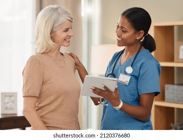 Youre going to be just fine. Shot of a doctor using a digital tablet during a consultation with a senior woman at home. - Powered by Shutterstock