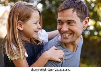 Youre My Hero Dad. Shot Of A Father Giving His Adorable Daughter A Piggyback Ride.