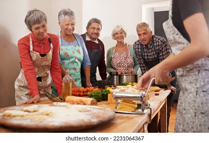 Youre never too old to learn. Shot of a group of seniors attending a cooking class. - Powered by Shutterstock