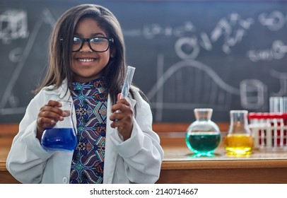 Youre never too young to pursue a love for science. Portrait of a little girl in a lab coat doing a science experiment in a lab. - Powered by Shutterstock