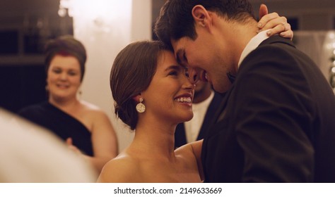 Youre so perfect. Cropped shot of an affectionate young newlywed couple slow dancing with their guests in the background at their wedding reception. - Shutterstock ID 2149633669
