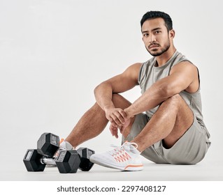 If youre persistent youll get it - if youre consistent youll keep it. Studio portrait of a muscular young man posing with dumbbells against a white background.